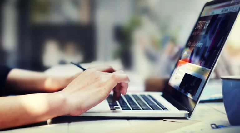 person typing on a MacBook